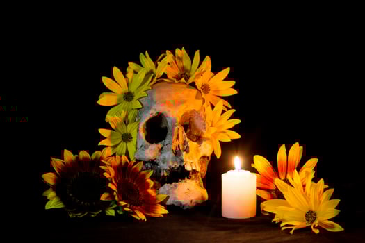 human skull with candles and flowers for the day of the dead photo