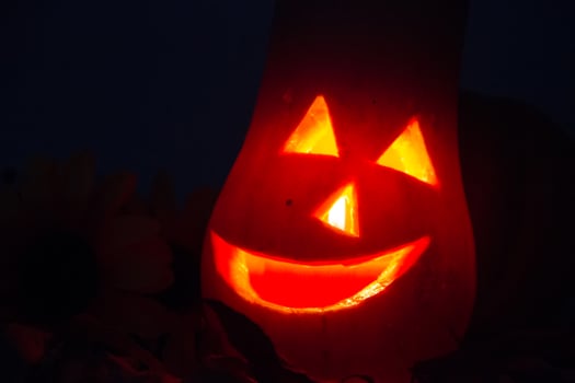 halloween candles and pumpkins in the dark photo