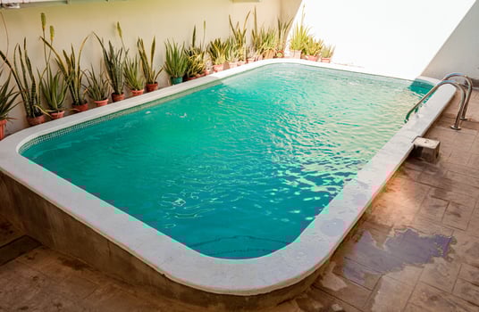 Beautiful home swimming pool with crystal clear waters. Crystal clear home swimming pool on a sunny day, Concept of home swimming pool designs photo