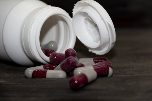 Detail of a bottle of capsules with medical drugs.Concept Medicine, health photo