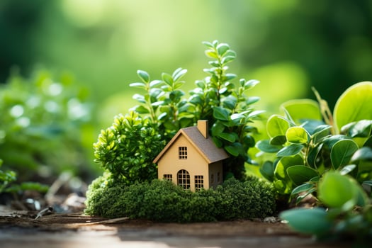 Miniature eco house situated in a green environment on grass photo