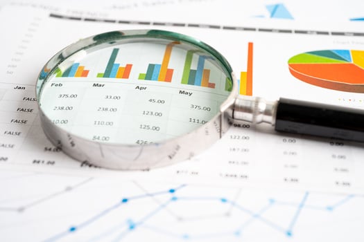 Magnifying glass on graph paper. Financial development, Banking Account, Statistics, Investment Analytic research data economy, Business concept. photo