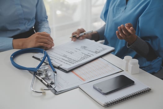 Asian doctor woman visited patient woman to diagnosis and check up health at home or private hospital. Female patient explain health problem and symptoms to doctor .Health care premium service at home photo
