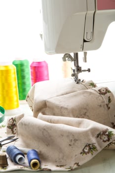 Sewing machine with fabric and threads for sewing, close-up. The working process photo