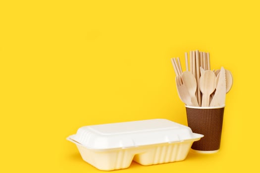 lunch box with disposable cutlery in a paper cup with copy space photo