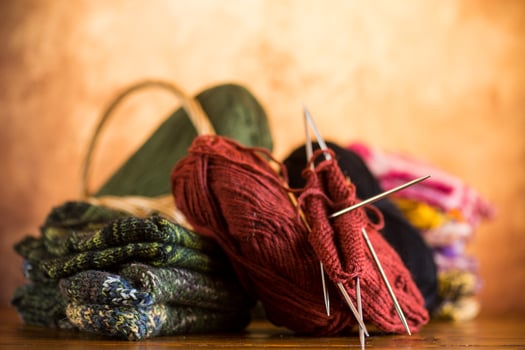 Colored yarn, knitting needles and other items for hand knitting . photo