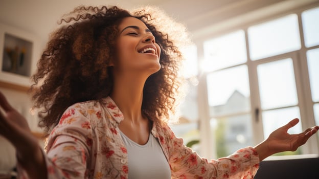 A Joyful African American Woman Dancing on her Sofa photo