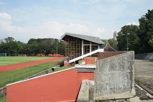 sports field with green grass and buildings photo