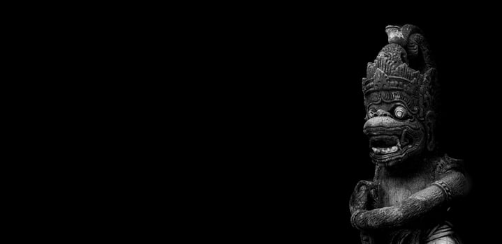 indian monkey, statue of hindu god hanoman on a black background photo