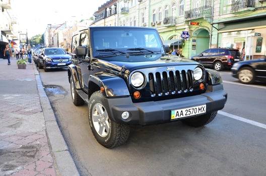 Jeep Wrangler Sahara Black with BFGoodrich All terrain T A tires on Kyiv street photo