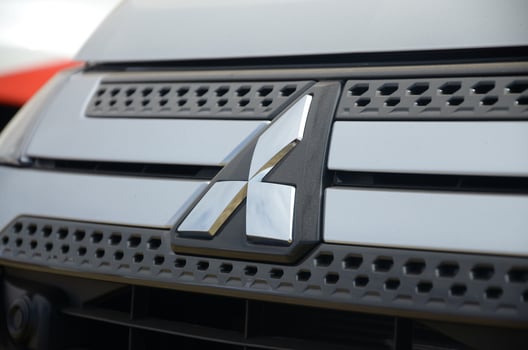 Mitsubishi logo in black car front part close up outdoors photo