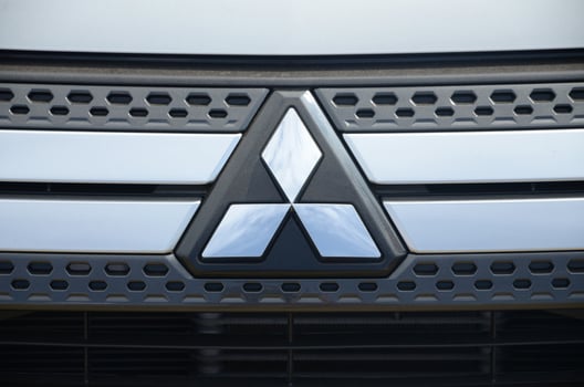 Mitsubishi logo in black car front part close up outdoors photo