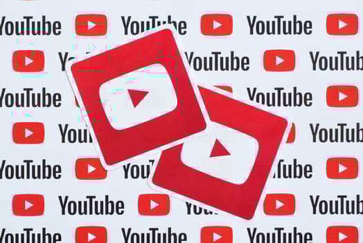 Youtube logo sticker on pattern printed on paper with small youtube logos and inscriptions. YouTube is Google subsidiary and American most popular video-sharing platform photo