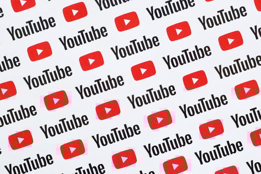 Youtube pattern printed on paper with small youtube logos and inscriptions. YouTube is Google subsidiary and American most popular video-sharing platform photo
