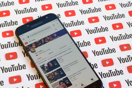 SET india official youtube channel on smartphone screen on paper youtube background. photo