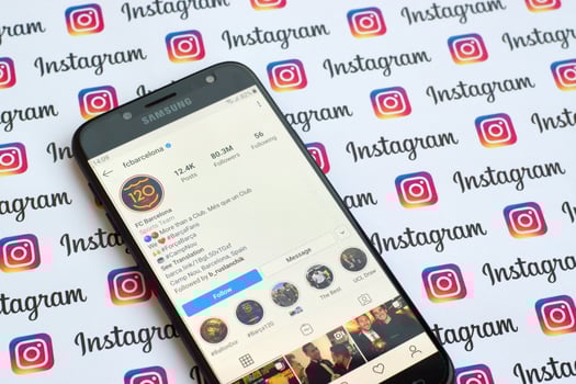 FC Barcelona official instagram account on smartphone screen on paper instagram banner. photo