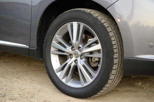 KHARKOV, UKRAINE - OCTOBER 21, 2019 Motor car Lexus RX350 AL10 in silver Color on country road. Wheel part view, Lexus is the luxury vehicle division of Japanese automaker Toyota photo