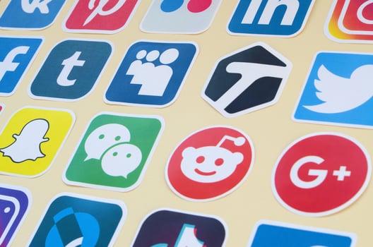 Many paper icons with logo of most popular social networks and smartphone apps for chat and conversations online photo