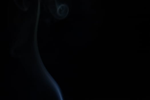 Blue smoke on a dark background photo