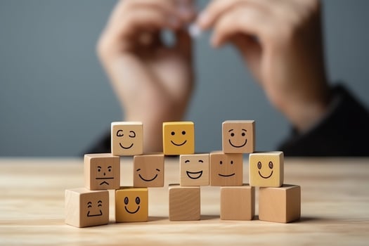 A wooden block label with happy smile relax face good feedback customer. World mental health day concept by AI Generated photo