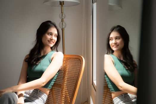 Beautiful asian woman sitting on chair and looking out the window photo
