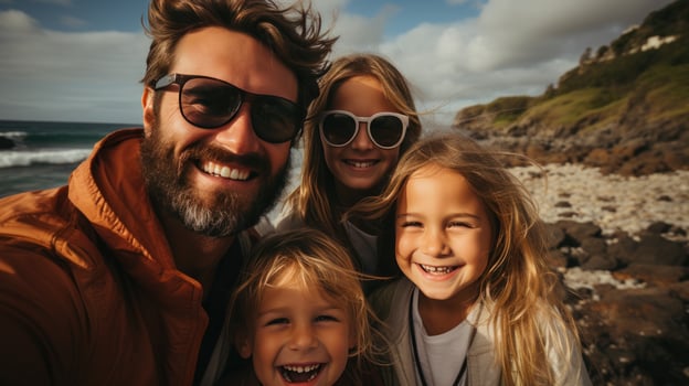 Excited family taking a group selfie on the shore photo