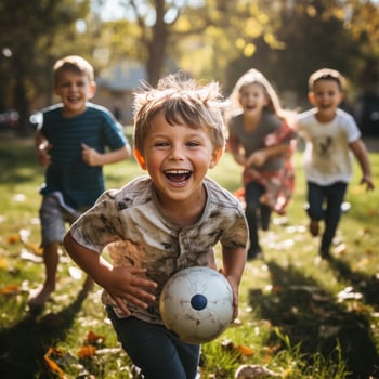 Kids having fun playing soccerfootball on the grass photo