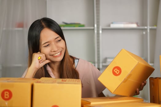 Online sellers check product boxes before delivering to customers. photo