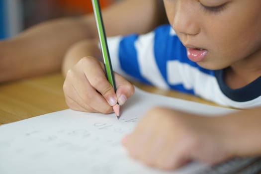 Boys practice writing numbers and letters. photo