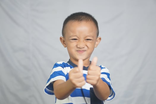 Happy boy taking pictures in the studio photo