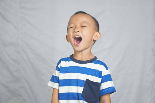 Happy boy taking pictures in the studio photo