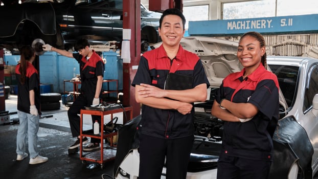 Portrait of professional mechanic partners arms crossed and look at camera, work at car service garage, happy maintenance jobs, check and repair engineer occupation in automotive industry business. photo