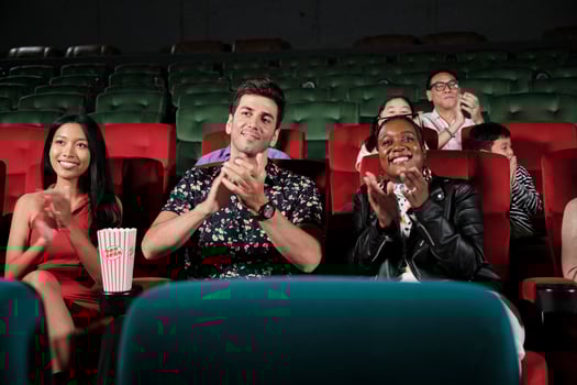 Various people in theater. Multiracial audiences, Black woman, and friends enjoy watching cinema and applauding together on movie shows, entertainment lifestyle with film, happy and cheerful smiles. photo