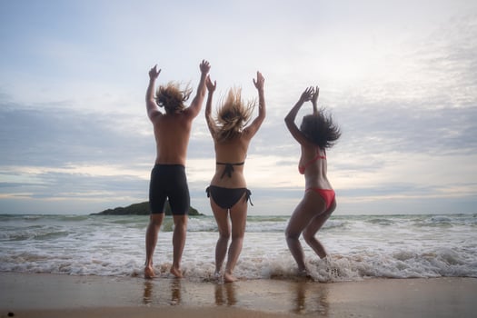 Group of friends having fun on the beach at the sunset time. photo