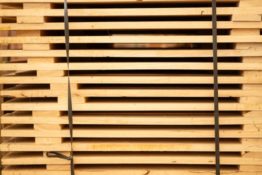 Wooden stacked in a warehouse, close-up. Wooden industrial background photo