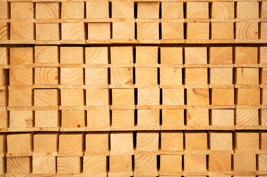 Wooden stacked in a warehouse, close-up. Wooden industrial background photo