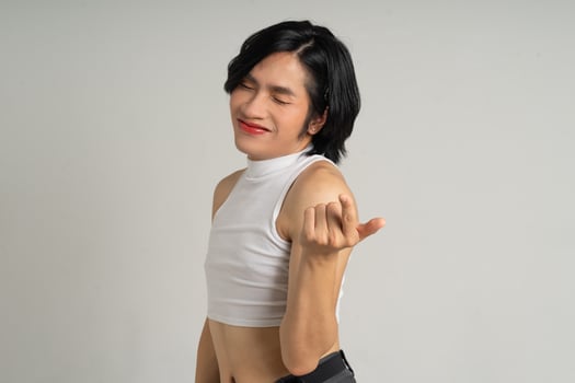 Portrait of gay man confidently posing on background photo