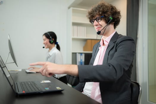 Group of business people wearing headset working actively in office. Call center, telemarketing, customer support agent provide service on telephone video conference call. photo