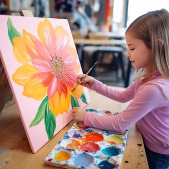 Little girl painting a flower with acrylics photo