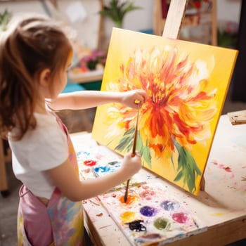 Little girl painting a flower with acrylics photo