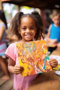 Child artist showing off their masterpiece to the camera photo