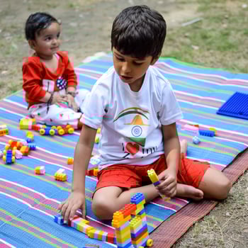 Two happy boys in society park, happy Asian brothers who are smiling happily together. Brothers play outdoors in summer, best friends. Toddler baby boy playing with his happy brother in the garden photo