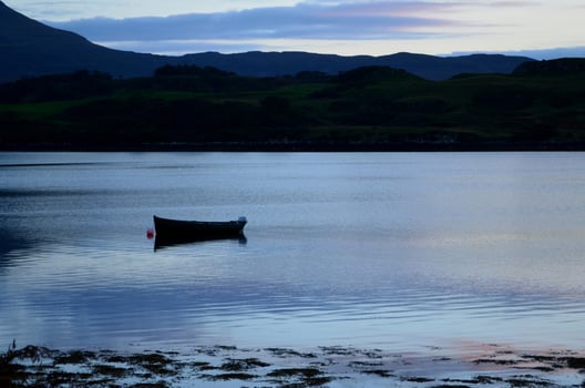 Silhouetted Dingy on Loch Dunvegan photo