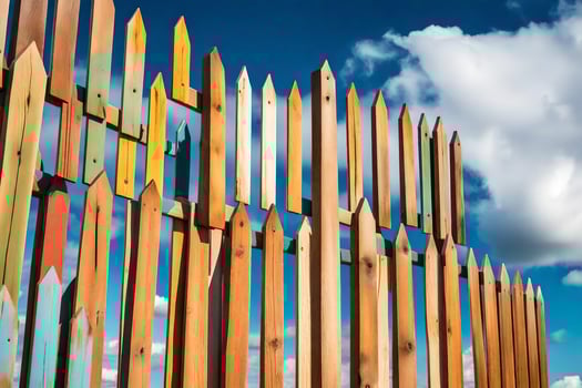 a wooden fence with many different colored wooden sticks. AI-Generated photo