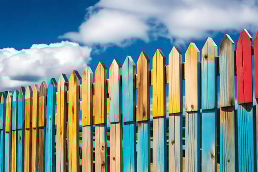 colorful wooden fence with blue sky and clouds. AI-Generated photo