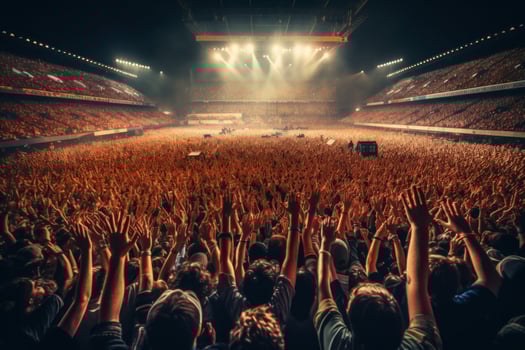 Wide-angle shot of a packed stadium during a concert with a sea of hands raised in the air. Generative Ai photo