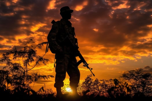 Patriotic Soldier Silhouette Against Vibrant Sunset Sky in War Scene - AI generated photo