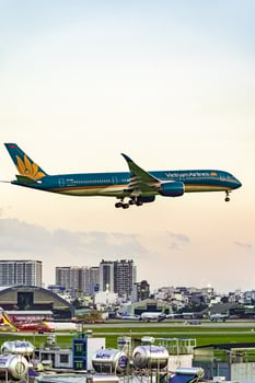 Ho Chi Minh, Vietnam - 7 August 2023 Airlines fly past landmark 81, the tallest building in Vietnam, to land at Tan Son Nhat international airport. photo