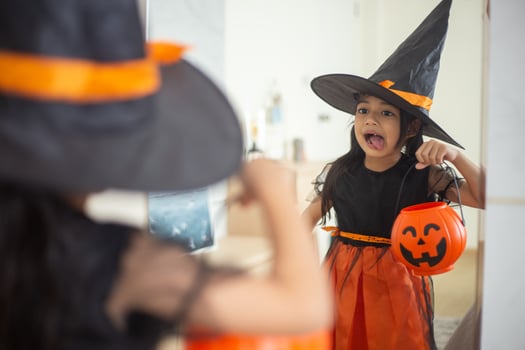Happy Asian child girl in a witch costume to Halloween. trick or treat. Kids trick or treating. photo