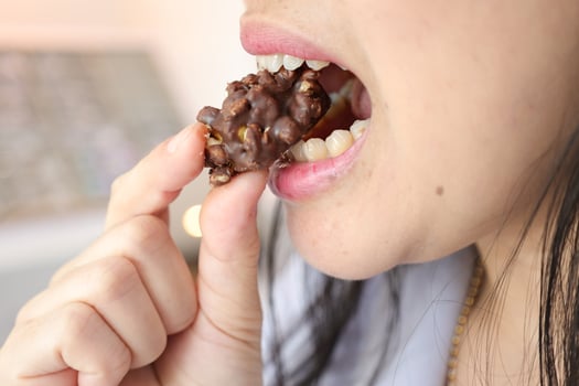 Close-up of a woman's mouth eating food photo